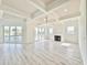 Living room featuring tray ceilings, light wood flooring, a fireplace, and sliding glass doors at 133 Serenity Point Dr., Little River, SC 29566
