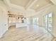 Spacious open-concept living space featuring white cabinetry, island and sliding glass doors at 133 Serenity Point Dr., Little River, SC 29566