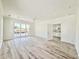 Spacious living room featuring gray hardwood floors, a ceiling fan, and sliding glass doors with water views at 133 Serenity Point Dr., Little River, SC 29566