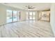 Bright living room with tile floors, ceiling fan, wet bar and glass sliding doors to the pool area at 133 Serenity Point Dr., Little River, SC 29566