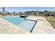 Gorgeous swimming pool featuring a black tiled water feature and travertine tiled pool deck, offering a luxurious outdoor space at 133 Serenity Point Dr., Little River, SC 29566