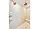 Luxurious walk-in shower with marble tiles, dual shower heads, and a built-in bench at 133 Serenity Point Dr., Little River, SC 29566
