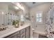 Bright bathroom featuring a double vanity, floral shower curtain, and nice finishings at 233 Astoria Park Loop, Conway, SC 29526