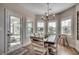 Dining room with large windows, a chandelier, and access to a sunroom at 233 Astoria Park Loop, Conway, SC 29526