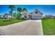 Inviting single-story home with a well-manicured lawn, landscaping, a two car garage, and a cozy front porch at 233 Astoria Park Loop, Conway, SC 29526