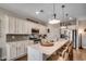 Modern kitchen with white cabinetry, stainless steel appliances, and a large island with seating at 233 Astoria Park Loop, Conway, SC 29526