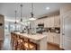 Bright kitchen features an island with decorative tiling, pendant lighting, and stainless steel appliances at 233 Astoria Park Loop, Conway, SC 29526