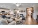 Open-concept living room with hardwood floors, leading to the kitchen and dining area at 233 Astoria Park Loop, Conway, SC 29526
