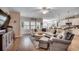 Spacious living room with hardwood floors, ceiling fan, and abundant natural light at 233 Astoria Park Loop, Conway, SC 29526
