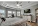 Main bedroom with tray ceiling, ensuite bathroom, large windows and a work space at 233 Astoria Park Loop, Conway, SC 29526