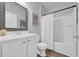 Clean bathroom featuring a white vanity, toilet, framed mirror and a shower with a white shower curtain at 2771 Eclipse Dr., Myrtle Beach, SC 29577