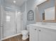 Bathroom with glass shower, wooden floors, white sink and mirror at 2771 Eclipse Dr., Myrtle Beach, SC 29577