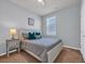 Comfortable bedroom with soft blue walls, a large bed, and a bright window offering neighborhood views at 2771 Eclipse Dr., Myrtle Beach, SC 29577