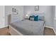 Comfortable bedroom with a white dresser, soft lighting, and a bed with teal pillows and a decorative print at 2771 Eclipse Dr., Myrtle Beach, SC 29577