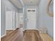 Bright entryway featuring wood floors, a white front door, and a cozy bench near the mirror accent at 2771 Eclipse Dr., Myrtle Beach, SC 29577