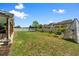Wide shot of the large grassy backyard with a trampoline, swing, and outdoor play tent at 3110 Bramble Glen Dr., Myrtle Beach, SC 29579