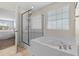 Bathroom featuring a white soaking tub with chrome fixtures and a glass-enclosed shower at 3110 Bramble Glen Dr., Myrtle Beach, SC 29579