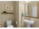 Half bathroom featuring pedestal sink, modern fixtures, framed art, and adjacent toilet at 3110 Bramble Glen Dr., Myrtle Beach, SC 29579