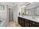 Bathroom featuring a double vanity, neutral color palette, soaking tub, and tile flooring at 3110 Bramble Glen Dr., Myrtle Beach, SC 29579