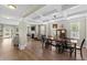 Elegant dining room features a coffered ceiling and an adjacent living room with a cozy fireplace at 3110 Bramble Glen Dr., Myrtle Beach, SC 29579