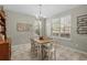 Charming dining room with natural light, stylish chandelier, and rustic wooden table at 3110 Bramble Glen Dr., Myrtle Beach, SC 29579
