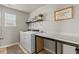 Well-lit laundry room with washer, dryer, folding counter, shelf, and ample space at 3110 Bramble Glen Dr., Myrtle Beach, SC 29579