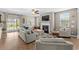 Bright living room with a fireplace, hardwood floors, and large windows offering an abundance of natural light at 3110 Bramble Glen Dr., Myrtle Beach, SC 29579