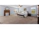 Spacious main bedroom with carpet, three windows, a ceiling fan, and vintage fireplace at 3110 Bramble Glen Dr., Myrtle Beach, SC 29579