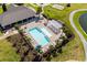 An aerial view of a community pool surrounded by palm trees, lounge chairs, and a pergola at 3110 Bramble Glen Dr., Myrtle Beach, SC 29579