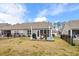 Backyard with a well-maintained lawn, patio, and black fencing at 328 Logan St., Little River, SC 29566