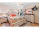 Inviting bedroom decorated with a beach theme, a dresser, and a mounted TV at 328 Logan St., Little River, SC 29566