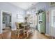 Bright dining room with seating for six, a decorative hutch, and stylish light fixture at 328 Logan St., Little River, SC 29566