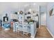 Stylish kitchen featuring white cabinets, granite countertops, a kitchen island with barstools, and stainless steel appliances at 328 Logan St., Little River, SC 29566