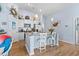 Bright kitchen featuring a granite breakfast island, white cabinets, and pendant lighting at 328 Logan St., Little River, SC 29566