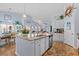 Open kitchen with granite countertops, an island with seating, and stainless steel appliances overlooking other living spaces at 328 Logan St., Little River, SC 29566