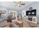 Comfortable living room features a ceiling fan and sliding glass doors leading to a patio at 328 Logan St., Little River, SC 29566