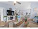 Cozy living room features coastal decor, a ceiling fan, and an entertainment center with a fireplace at 328 Logan St., Little River, SC 29566