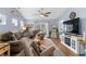 Comfortable living room features a ceiling fan and sliding glass doors leading to a patio at 328 Logan St., Little River, SC 29566
