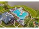 Aerial view of a unique pool design with lounging area and manicured landscaping at 328 Logan St., Little River, SC 29566