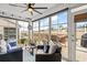 Relaxing sunroom with large windows, comfortable seating, and views of the yard at 328 Logan St., Little River, SC 29566