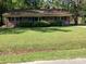 Charming single-story brick home with a well-manicured lawn and mature trees at 4011 Southern Cross Rd., Myrtle Beach, SC 29579