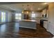 Modern kitchen with stainless steel appliances, granite countertops, island, and adjacent dining area with sliding glass doors at 4027 Bucolic Loop, Myrtle Beach, SC 29588