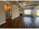 Open living room featuring hardwood floors, a fireplace, coffered ceilings, and an abundance of natural light at 4027 Bucolic Loop, Myrtle Beach, SC 29588