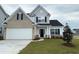 Charming two-story home featuring a brick and white facade, black shutters, and a well-manicured lawn at 4047 Bucolic Loop, Myrtle Beach, SC 29588