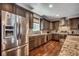 Kitchen with stainless steel refrigerator, mosaic backsplash, and wood floors at 4964 Salt Creek Ct., North Myrtle Beach, SC 29582