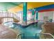 Bright indoor pool area with unique colorful columns and a shallow, winding pool at 6804 Ocean Blvd. N # 625, Myrtle Beach, SC 29572