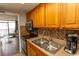 Cozy kitchenette with stainless steel appliances, wood cabinets, and a cozy breakfast bar at 6804 Ocean Blvd. N # 625, Myrtle Beach, SC 29572