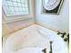 Close-up of a jetted tub featuring bronze-colored fixtures under a window for optimal natural light at 710 Masters Dr., Pawleys Island, SC 29585