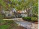 Beautiful exterior with a long driveway and attached garage nestled among mature trees and landscaping at 710 Masters Dr., Pawleys Island, SC 29585