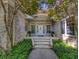 Inviting front porch with brick steps, pillars, and mature trees and landscaping at 710 Masters Dr., Pawleys Island, SC 29585